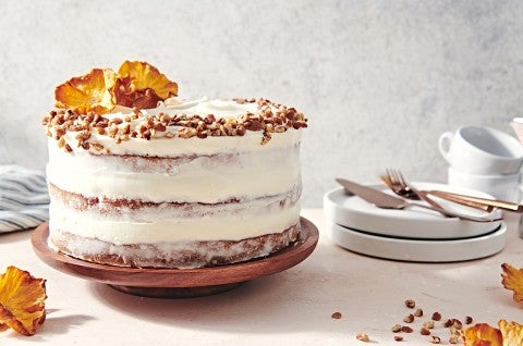 A Hummingbird Cake with a pineapple cream cheese frosting and dried pineapple and toasted nuts on top. - select to zoom