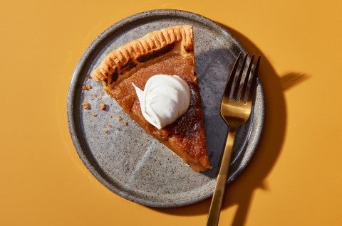 A slice of Maple Cream Pie on a plate topped with whipped cream - select to zoom