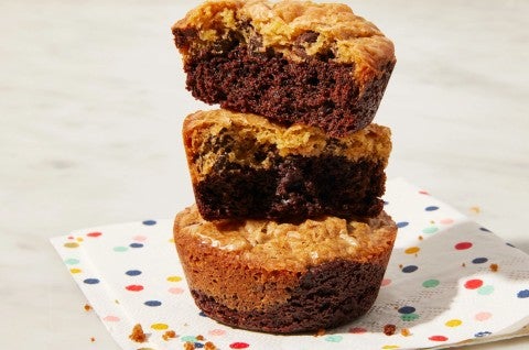 Stack of three brownie cookies on a colorful napkin. 