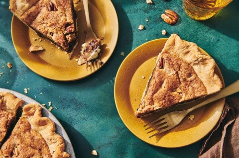 A few slices of Chocolate Chip Pecan Pie on plates with forks - select to zoom