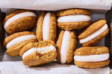 Oatmeal Cream Pies in a basket showing one with a bite taken out. - select to zoom