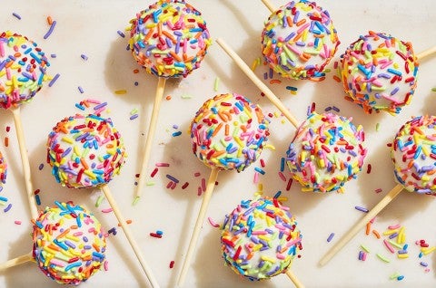 Confetti Cake Pops on a countertop seen from above. - select to zoom