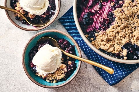 Blueberry Crisp in a round King Arthur Baking pie tin and also in a bowl topped with ice cream - select to zoom