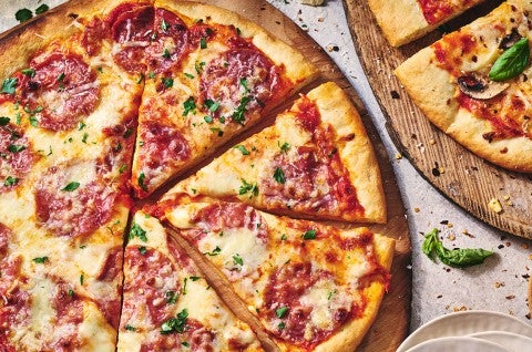 Two pizzas seen from above on wooden pizza peels - select to zoom