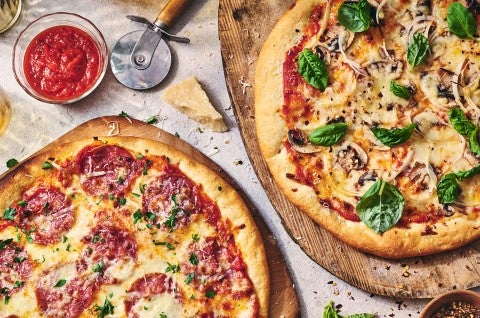 Two pizzas seen from above on wooden pizza peels - select to zoom