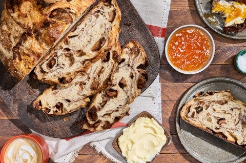 Apple Cinnamon Sourdough Bread sliced and seen from above with decorations on a counter - select to zoom