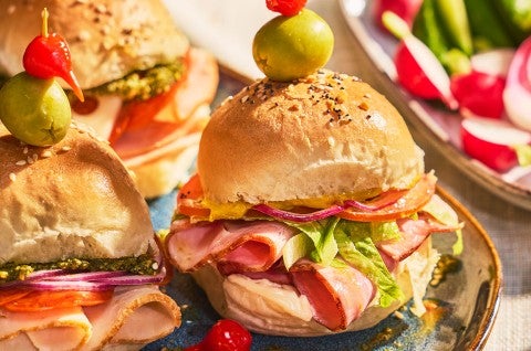 Hot Party Sandwiches on an elaborate table with other vegetables, dips, and lunch items - select to zoom