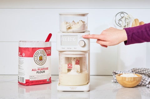 Pressing start on an automatic sourdough feeder, the Sourdough Sidekick