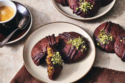 Dubai Chocolate Cookies arranged on a counter and plate with a cup of coffee - select to zoom