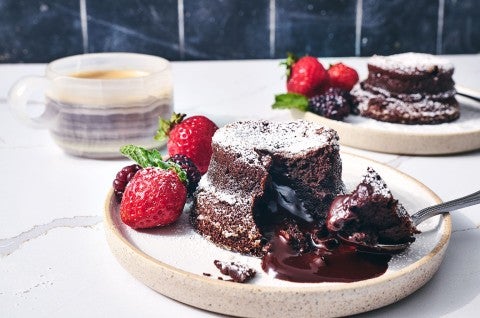 Flourless Chocolate Lava Cake on a white plate sitting on a counter - select to zoom