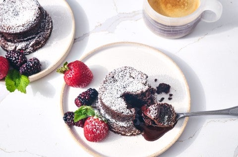 Flourless Chocolate Lava Cake seen from above with a scoop of gooey cake on a spoon - select to zoom