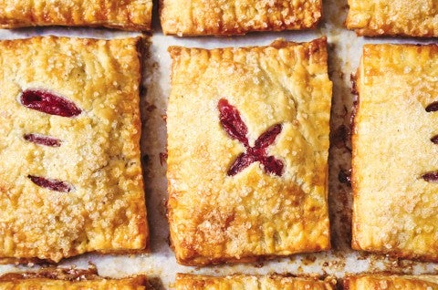Strawberry Hand Pies on a baking sheet fresh out of the oven - select to zoom