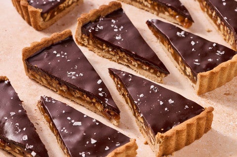 Slices of Candy Bar Pecan Tart arranged neatly on a counter - select to zoom