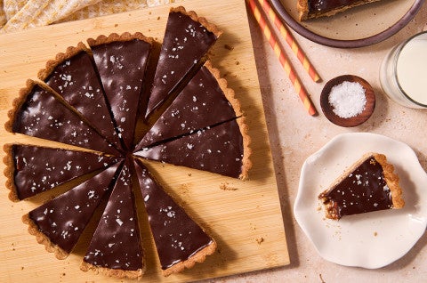 Candy Bar Pecan Tart seen from above - sliced on a cutting board - select to zoom