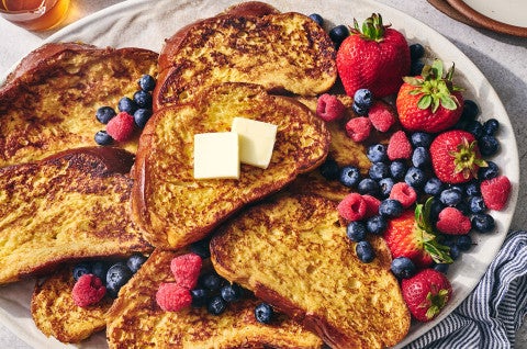 French Toast on a plate surrounded by fresh berries - select to zoom