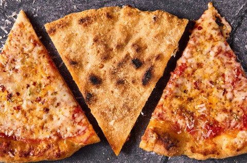 Three slices of Gluten Free NY Style Pizza with the middle one face down to show the well baked GF crust. - select to zoom
