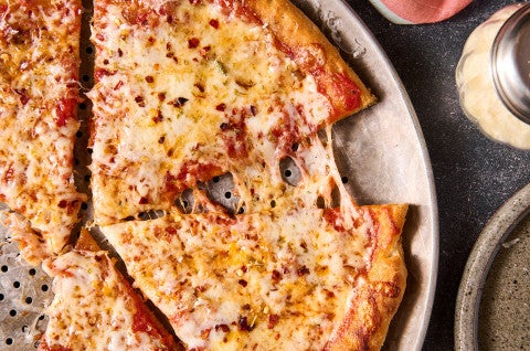 Gluten Free NY Style Pizza on a pizza pan seen from above. - select to zoom