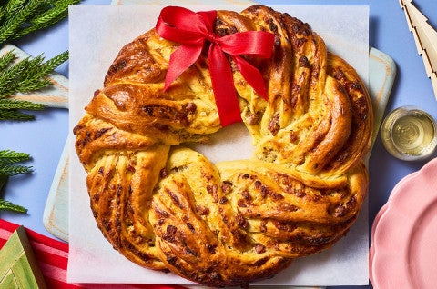 Italian Herb & Cheese Wreath on a cutting board seen from above. - select to zoom