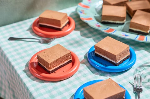 No-Bake Chocolate Cheesecake Bars arranged on a table - select to zoom
