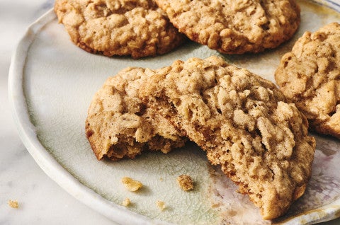 Oatmeal Cookies on a plate, one has a bite take out of it. - select to zoom