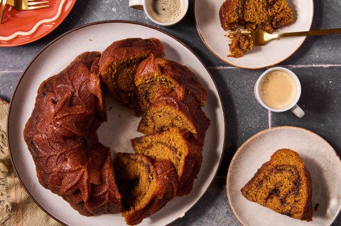 Pumpkin Espresso Bundt Cake shown in the shape of the bundt can but sliced - select to zoom