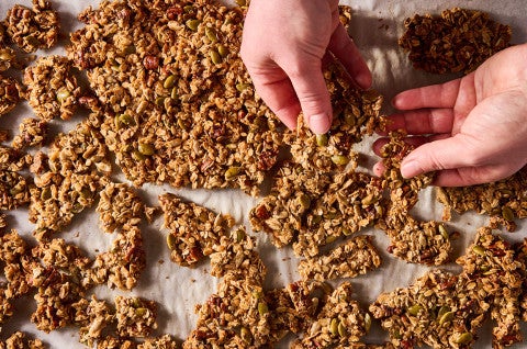 Breaking Sourdough Granola apart fresh out of the oven - select to zoom