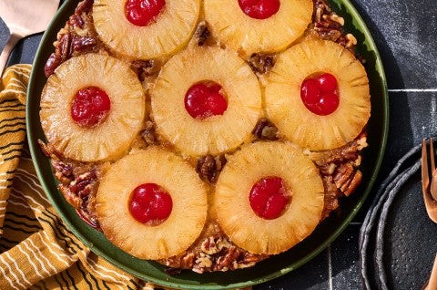 Pineapple Upside Down Cake seen from above with caremelized pineapple rings filled with maraschino cherries - select to zoom