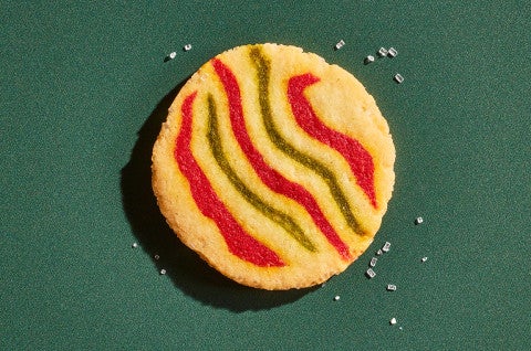 A Ribboned Peppermint Shortbread Cookie on a green background - select to zoom