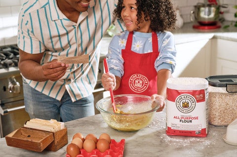 A father and son making oatmeal chocolate chip cookies - select to zoom