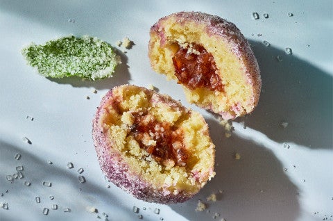 A halved Sugar Plum Cookie on a counter showing the filling and tender cookie - select to zoom