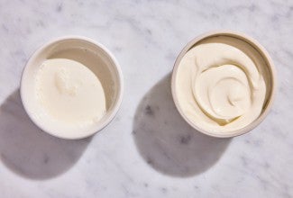 A bowl of leftover heavy cream next to a bowl of creme fraiche