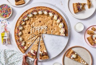 Chocolate Chip Cookie Cake on a counter with slices removed.