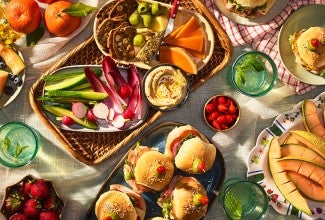Hot Party Sandwiches on an elaborate table with other vegetables, dips, and lunch items
