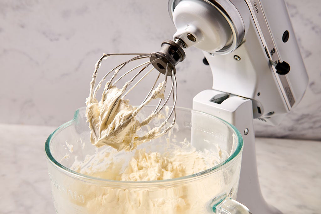 Mixing Italian Buttercream with a whisk attachment on a stand mixer