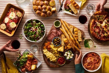 Spread of savory breads and accompanying dishes on a dinner table