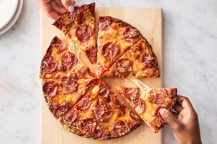 Easy Pan Pizza sliced up on a cutting board