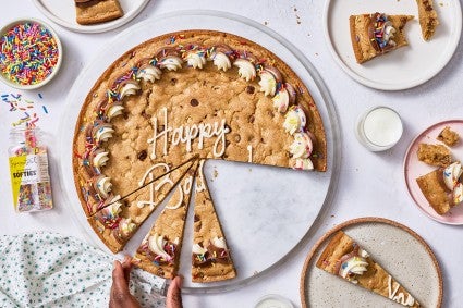 Chocolate Chip Cookie Cake on a counter with slices removed.