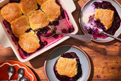 Sourdough Discard Blueberry Cobbler in a pan with slices on plates seen from above