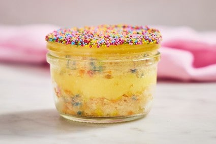2 layered dot cake with frosting and sprinkles