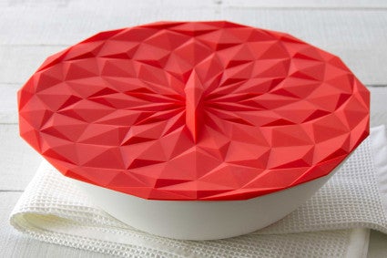 Red suction lid over white bowl