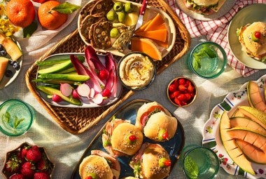 Hot Party Sandwiches on an elaborate table with other vegetables, dips, and lunch items