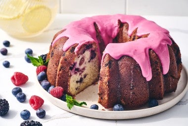 Berry Bliss Bundt Cake seen from the side with berries around the edges